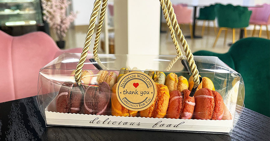 a gift box of macarons on top of a table at Patisserie Luxe's cafe