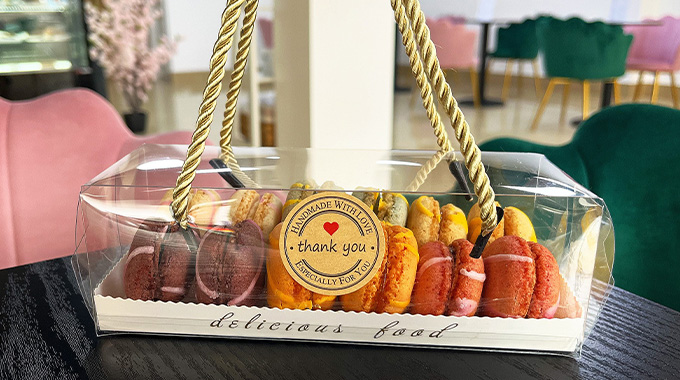 a gift box of macarons on a table a Patisserie Luxe - a patisserie in Poole